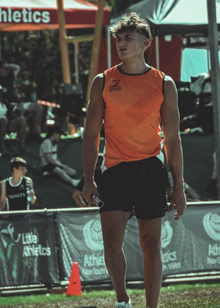 Dylan at a track meet holding a baton